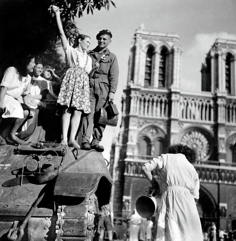 FRANCE - AUGUST 25:  World War II. Liberation of Paris on August 25, 1944, 7a.m. in front of the Cathedral of Notre-Dame. On the tank, Michel Frys, who was later wounded by an ambushed German.  (Photo by Gaston Paris/Roger Viollet/Getty Images)