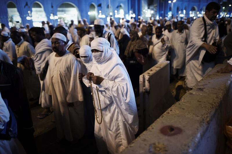 Muslim pilgrims leave after the isha prayer at Mecca’s Grand Mosque on September 28, 2014. Mohammed Al Shaikh / AFP Photo