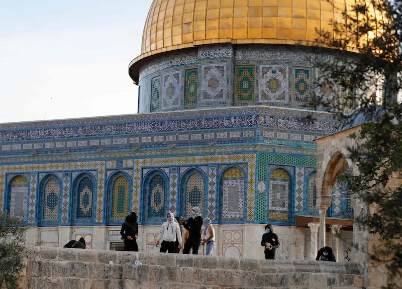 Protesters stand beside the Dome of the Rock shrine in Al Aqsa Mosque compound.
AFP