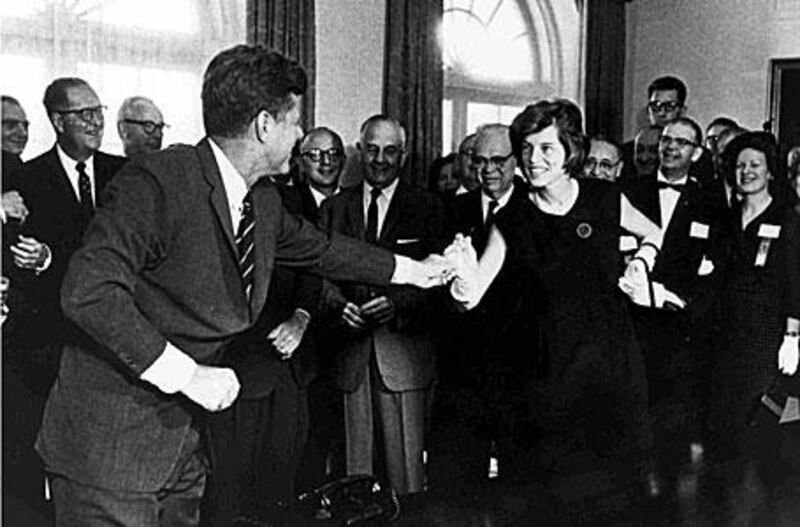 Eunice Mary Kennedy Shriver is greeted by her brother, then-president John F Kennedy.