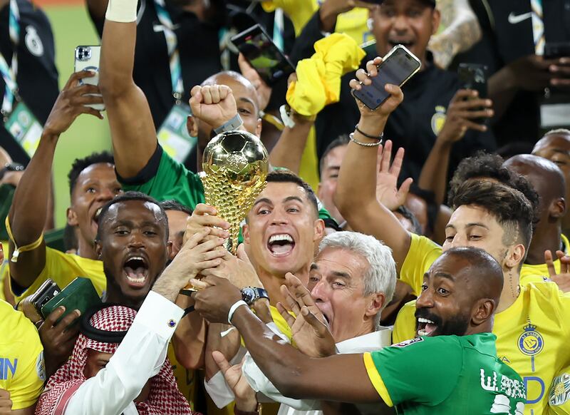 RIYADH, SAUDI ARABIA - AUGUST 12: Cristiano Ronaldo of Al Nassr lifts the Arab Club Champions Cup trophy with teammates after the team's victory in the Arab Club Champions Cup Final between Al Hilal and Al Nassr at King Fahd International Stadium on August 12, 2023 in Riyadh, Saudi Arabia. (Photo by Yasser Bakhsh / Getty Images)