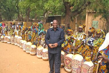 Dr Kouyate stands with Nigerien women dressed in traditional clothing Dr Kouyate/The National