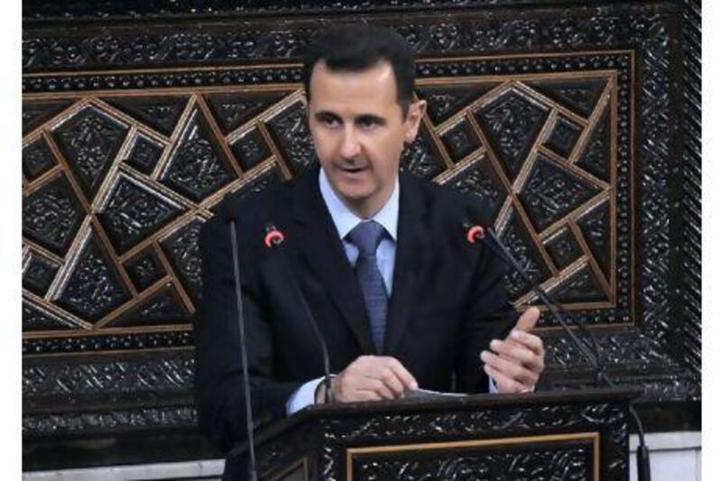 Syrian president Bashar al Assad addresses the nation during a speech to parliament in Damascus yesterday in which he blamed the wave of protests against his authoritarian rule on 'conspirators' and failed to offer any concessions to appease the wave of dissent.