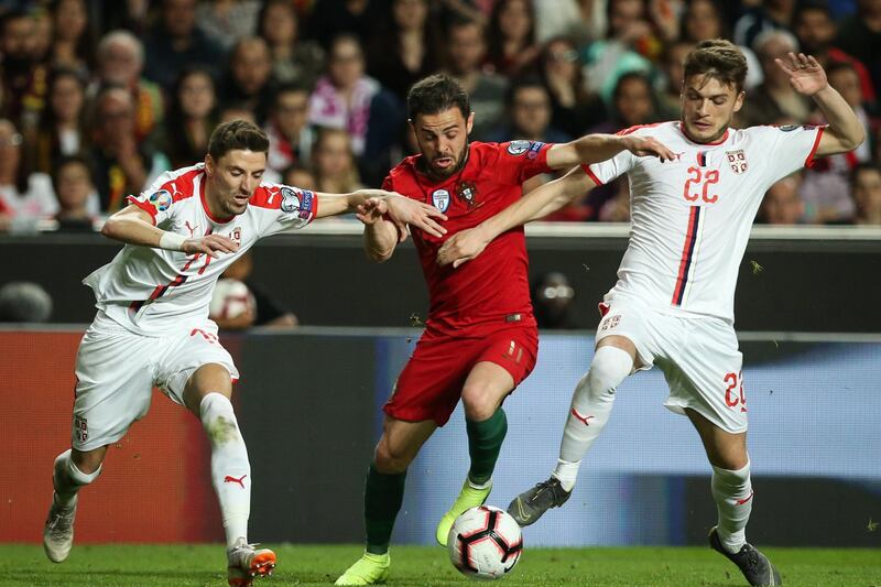 City's Bernardo Silva fights for the ball with Serbia's Filip Mladenovic (L) and Adem Ljajic during the UEFA EURO 2020 Group B qualifying match.  EPA