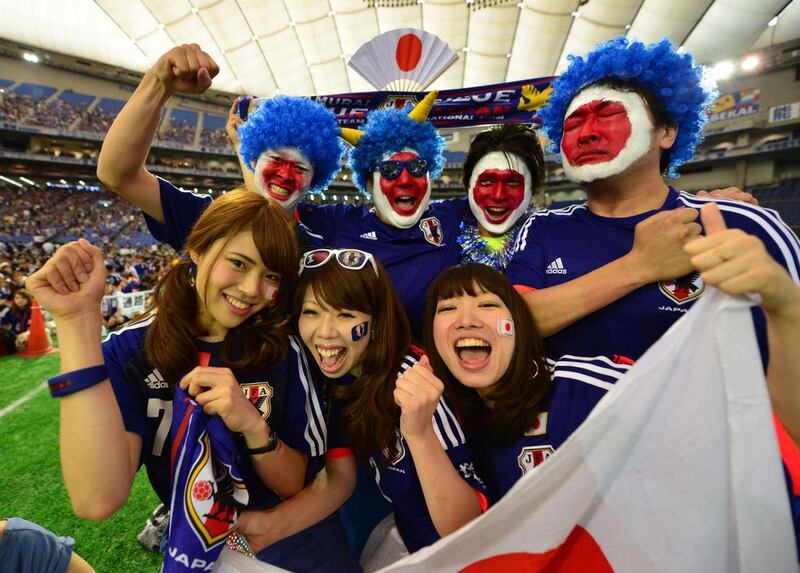 Japanese football supporters cheer for Japan's national team before starting a public viewing of the Group C match against Ivory Coast on Sunday in Tokyo. Yoshikazu Tsuno / AFP