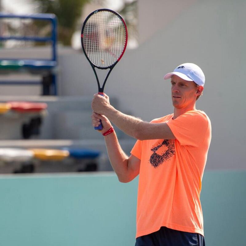 Tennis player Kevin Anderson wears the red wrist band signifying his support for the Special Olympic World Games during a Tennis clinic held during the Mubadala Tennis Championships in Abu Dhabi. Courtesy Special Olympics World Games Abu Dhabi Twitter