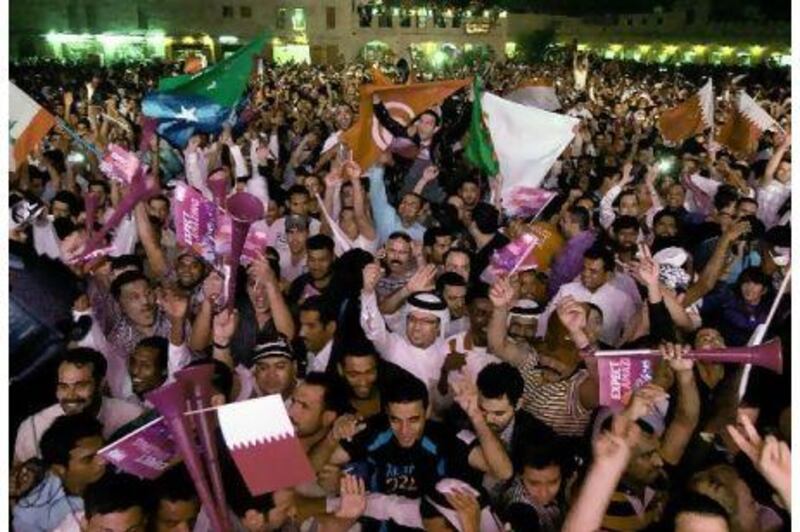 Doha residents take to the streets last night to celebrate the announcement that the 2022 World Cup will be hosted by Qatar. 
Marwan Naamani / AFP