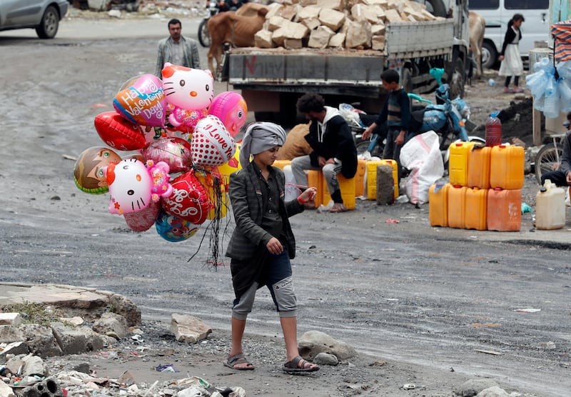 epa08575285 A Yemeni vendor displays colorful balloons for sale ahead of the Muslim festival of Eid al-Adha, in Sana'a, Yemen, 30 July 2020. Eid al-Adha is the holiest of the two Muslims holidays celebrated each year, it marks the yearly Muslim pilgrimage (Hajj) to visit Mecca, the holiest place in Islam. Muslims slaughter a sacrificial animal and split the meat into three parts, one for the family, one for friends and relatives, and one for the poor and needy.  EPA/YAHYA ARHAB