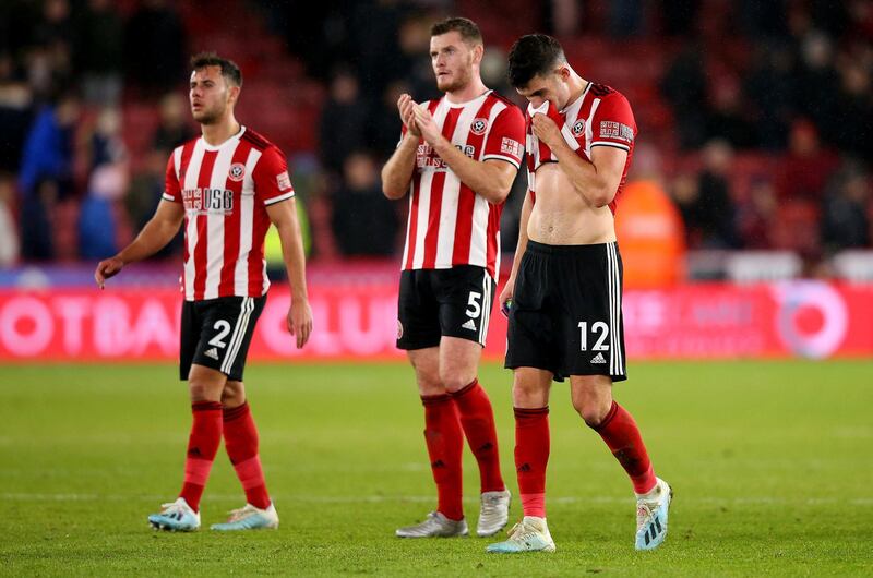SHEFFIELD, ENGLAND - DECEMBER 05: John Egan #12 of Sheffield looks dejected after the Premier League match between Sheffield United and Newcastle United at Bramall Lane on December 05, 2019 in Sheffield, United Kingdom. (Photo by Alex Livesey/Getty Images)