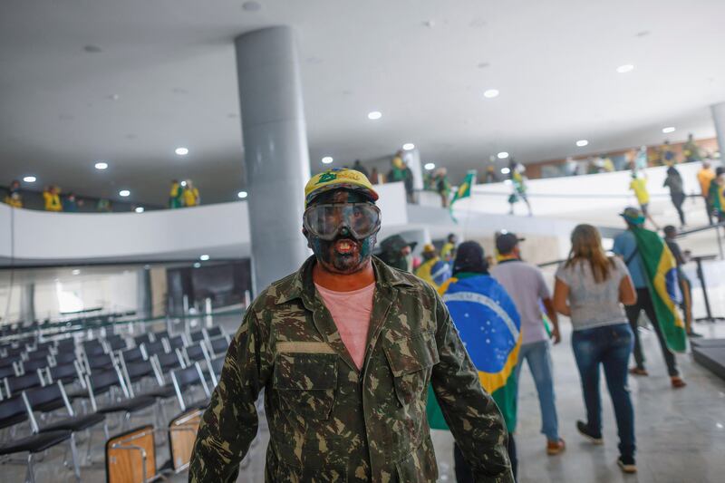 A supporter of Jair Bolsonaro inside the presidential palace. Reuters