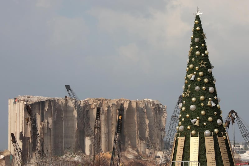 A Christmas tree with names of those who died during Beirut port explosion, is seen near the damaged grain silo, in Beirut, Lebanon December 22, 2020. REUTERS/Mohamed Azakir