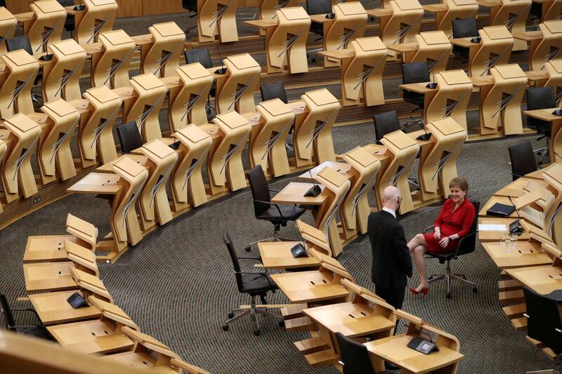 Scotland's First Minister Nicola Sturgeon sits in an empty Scottish Parliament in Edinburgh. AFP