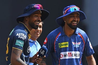 Gujarat Titans' captain Hardik Pandya (L) and his Lucknow Super Giants' counterpart Krunal Pandya smile during the toss before the start of the Indian Premier League (IPL) Twenty20 cricket match between Gujarat Titans and Lucknow Super Giants at the Narendra Modi Stadium in Ahmedabad on May 7, 2023.  (Photo by INDRANIL MUKHERJEE  /  AFP)