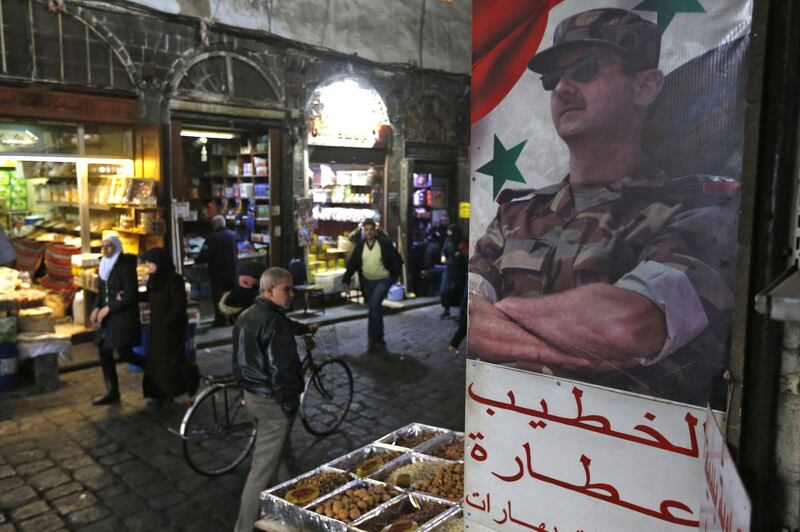A picture of Syrian President Bashar al-Assad decorates the al-Buzuriya market in the Old City of the Syrian capital Damascus on February 12, 2020. Syrian regime forces today pushed on with their offensive in the country's northwest, securing areas along a key national highway they seized, as tensions spiralled with Turkey which supports rebel groups. After a series of tit-for-tat attacks, Turkish President Recep Tayyip Erdogan threatened to strike Syrian regime forces "everywhere" if his soldiers are harmed and accused Damascus ally Russia of committing "massacres".
 / AFP / LOUAI BESHARA
