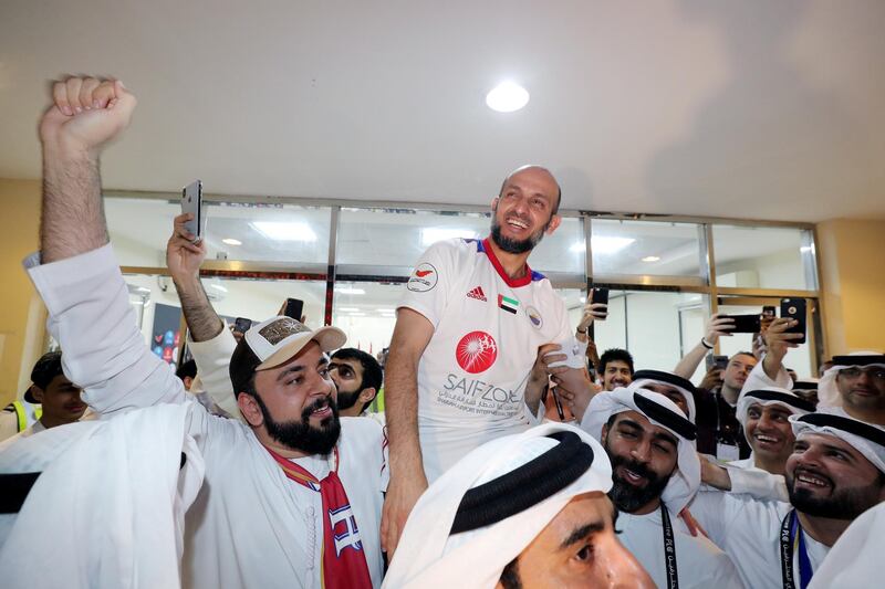 Sharjah, United Arab Emirates - May 15, 2019: Football. Sharjah manager Abdulaziz Alyassi is lifted onto peoples shoulders to celebrate winning the league after the game between Sharjah and Al Wahda in the Arabian Gulf League. Wednesday the 15th of May 2019. Sharjah Football club, Sharjah. Chris Whiteoak / The National