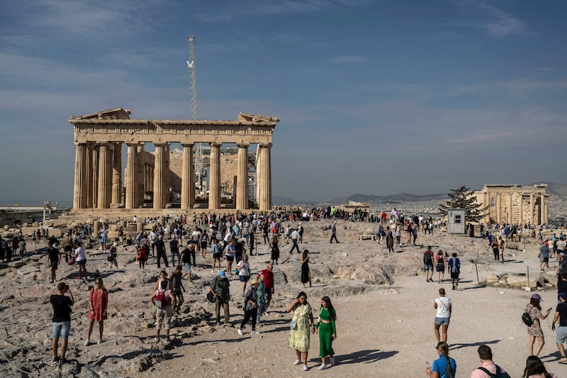 Tourists visit the Acropolis hill and 2,500-year-old Parthenon temple. AP