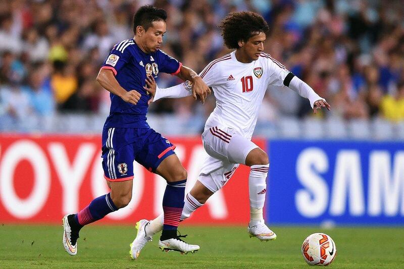 Yuto Nagatomo, left, of Japan chases down Omar Abdulrahman, right, of UAE during their Asian Cup quarter-final match on Friday in Sydney. Paul Miller / EPA