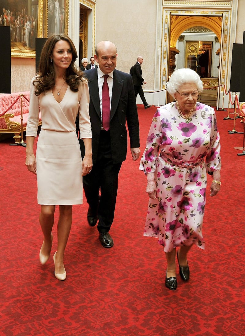 LONDON, UNITED KINGDOM - JULY 22: Britain's Queen Elizabeth II  walks with Catherine, Duchess of Cambridge as they view the exhibitions for the summer opening of Buckingham Palace on July 22, 2011 in London, England. The Duchess of Cambridge's intricately decorated wedding dress, designed by Sarah Burton of Alexander McQueen is currently on display at Buckingham Palace (Photo by John Stillwell - WPA Pool/Getty Images)