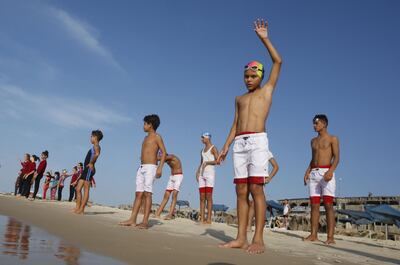 Young Palestinian members of a swimming club, participate in a group excercise on the beach during a training session in Beit Lahia in the northern Gaza Strip, on October 4, 2018. On one of the world's most polluted beaches, 30 young Palestinians dive head first into the sea off the coast of Gaza, their minds filled with dreams of Olympic glory. 
Aged between 11 and 16, they make up a rare swimming club in the Gaza Strip, and perhaps its only mixed-sex one.
 / AFP / SAID KHATIB
