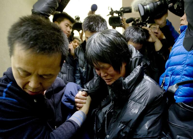 A Chinese relative of passengers aboard a missing Malaysia Airlines plane cries as she leaves a hotel room for relatives or friends of passengers aboard the missing plane. Andy Wong / AP Photo