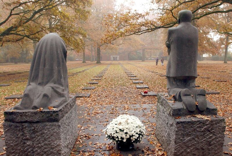 FILE - In this Nov. 11, 2003, file photo, a sculpture entitled "Mourning Parents" by German artist Kaethe Kollwitz looks over a German World War I cemetery in Vladslo, Belgium. France and Belgium are urging UNESCO to designate scores of their World War I memorials and cemeteries as World Heritage sites as the centennial remembrance of the 1914-1918 war nears its end. (AP Photo/Virginia Mayo, File)