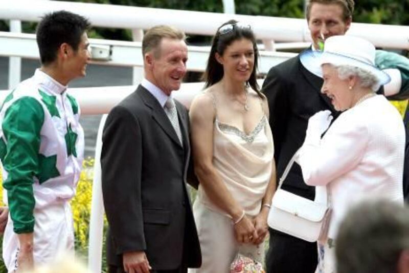 Queen Elizabeth II (R) talks to the horse trainer for "King & Kong" Steven Burridge (2nd at L) and Jockey Richard Lim (L) at the Queen Elizabeth II Cup in Singapore 18 March 2006. Queen Elizabeth II presented the winner's cup at a Singapore horse race first held in her honour 34 years ago, ending a sentimental two-day visit to the former British colony with which she said ties are as strong as ever.  AFP PHOTO/ ROSLAN RAHMAN