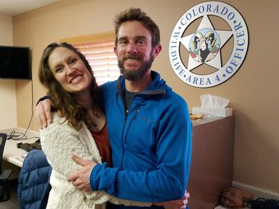 FILE PHOTO: Travis Kauffman, a trail runner who fought off a mountain lion attack at Horsetooth Mountain, in Larimer County, Colorado on February 4, embraces Annie Bierbouer before a news conference at Colorado Parks & Wildlife office in Fort Collins, Colorado, Feb. 14, 2019. Courtesy of Colorado Parks & Wildlife/Handout via REUTERS   ATTENTION EDITORS - THIS IMAGE HAS BEEN SUPPLIED BY A THIRD PARTY/File Photo