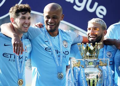 epa07565268 Manchester City captain Vincent Kompany (C) celebrates with teammates John Stones (L) and Sergio Aguero after the English Premier League match between Brighton and Hove Albion and Manchester City, Brighton, Britain, 12 May 2019. Manchester City won 4-1 and won the Premier League title.  EPA/JAMES BOARDMAN EDITORIAL USE ONLY.  No use with unauthorized audio, video, data, fixture lists, club/league logos or 'live' services. Online in-match use limited to 120 images, no video emulation. No use in betting, games or single club/league/player publications.