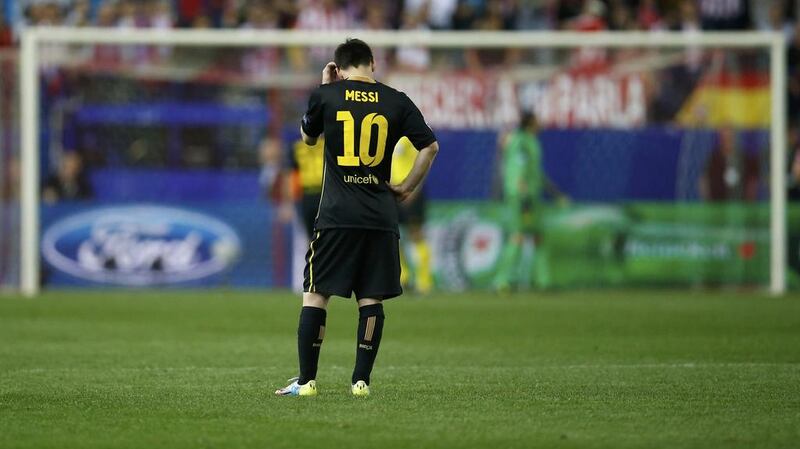 FC Barcelona striker Lionel Messi reacts during his team's loss to Atletico Madrid. Juan Medina / Reuters / April 9, 2014