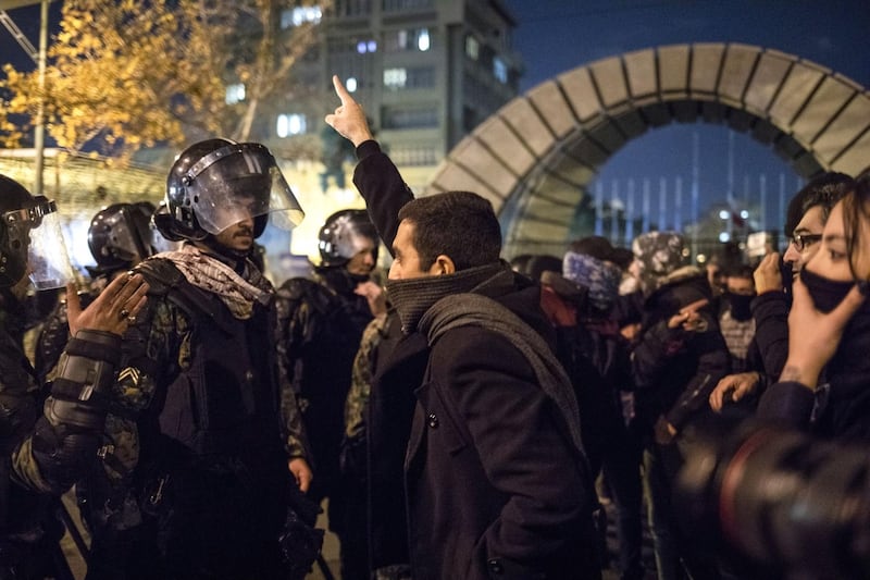 An Iranian man confronts riot police during a demonstration outside Tehran's Amir Kabir University.  AFP