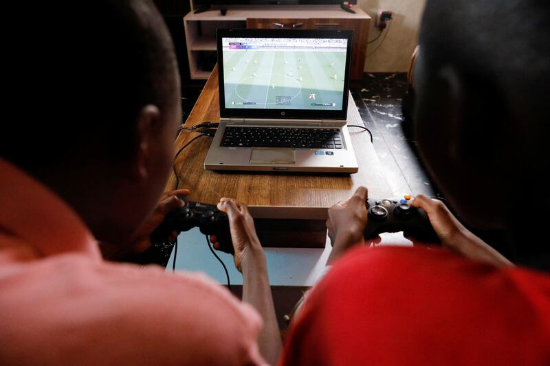 Udom Ukeme, 11 and his brother, Udom Idongesit, 13, play a Vikseen Virtual video game, at their home in Ogun State, Nigeria, June 23, 2022.  REUTERS / Temilade Adelaja