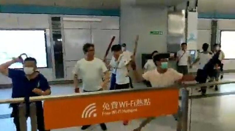 Men in white shirts and face masks attack anti-extradition bill demonstrators and reporters at a train station in Hong Kong, China. Courtesy of Stand News / Social Media via Reuters