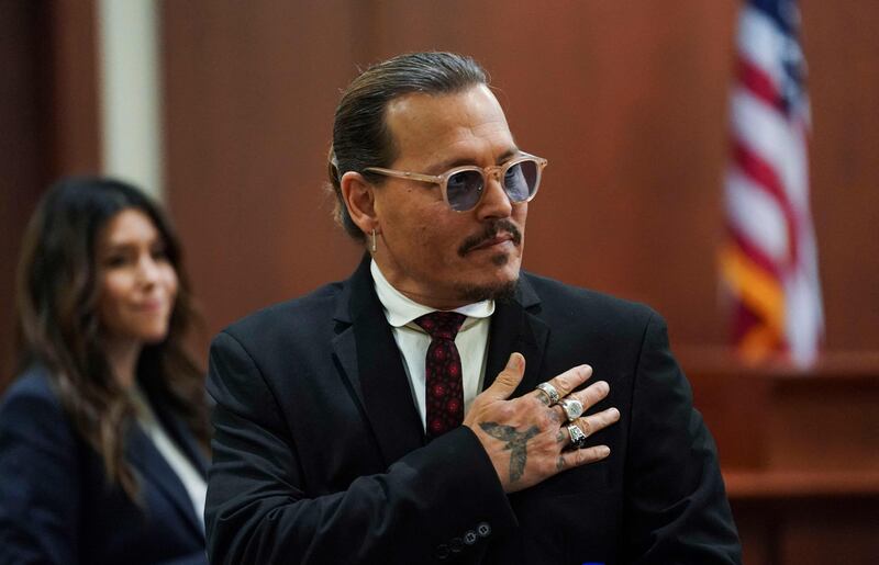 Depp acknowledges supporters before a lunch break. AFP