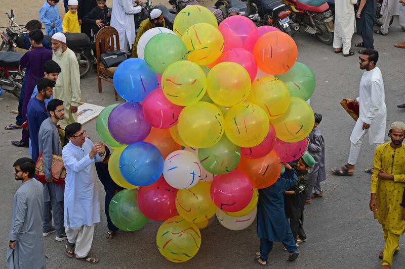 A street vendor offers balloons for sale to mark the Eid celebration in Karachi, Pakistan. AFP