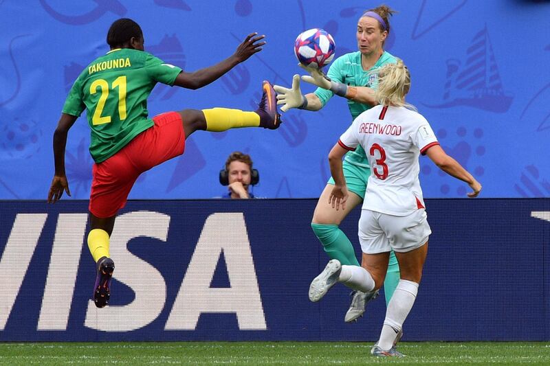 England's goalkeeper Karen Bardsley (C) vies with Cameroon's forward Alexandra Takounda (L) during the France 2019 Women's World Cup round of sixteen football match between England and Cameroon, on June 23, 2019, at the Hainaut stadium in Valenciennes, northern France. (Photo by Philippe HUGUEN / AFP)