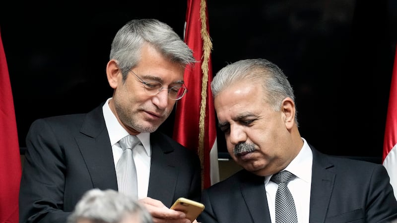 Lebanon's Energy Minister Walid Fayad, left, speaks with Syria's Electricity Minister Ghassan Al Zamil during the signing ceremony for deals to bring electricity from Jordan to Lebanon through Syria in Beirut on January 26, 2022. AP
