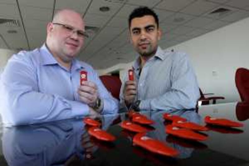 
DUBAI, UNITED ARAB EMIRATES, Feb 22: Left to Right- David McKern, Chief Marketing Officer and Ahmad Zahran Chief Executive Officer of Infinitec with ÔInfinitÕ memory sticks at their office in the Liwa Heights tower in Jumeirah Lake Towers Dubai. (Pawan Singh / The National) For News. 