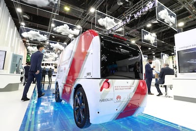Dubai, United Arab Emirates - December 06, 2020: A visitor walks passed the AI & 5G Autonomous Vehicle from Huawei during GITEX 2020 at the World Trade Centre. December 6th, 2020 in Dubai. Chris Whiteoak / The National