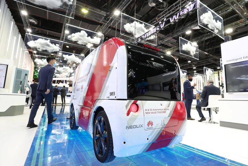 Dubai, United Arab Emirates - December 06, 2020: A visitor walks passed the AI & 5G Autonomous Vehicle from Huawei during GITEX 2020 at the World Trade Centre. December 6th, 2020 in Dubai. Chris Whiteoak / The National