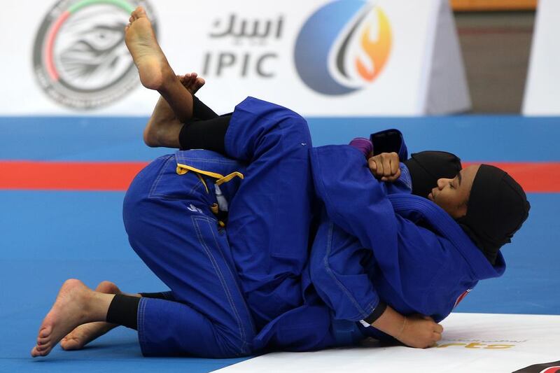 Hessa Thani Bakhit (bottom) held a tight lock on her opponent, Hasa Saeed Al Mazrouei to take the win. Delores Johnson / The National