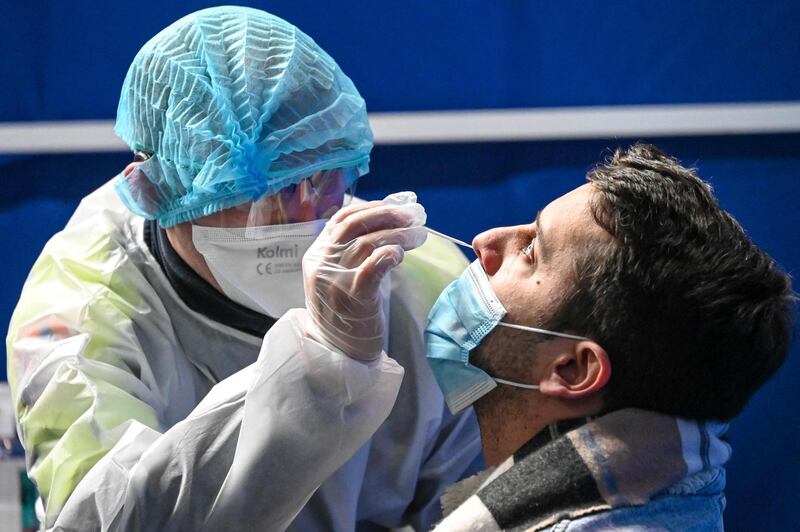 A health worker takes a nasal swab on a man in a testing centre at the Dunkirk convention centre. AFP
