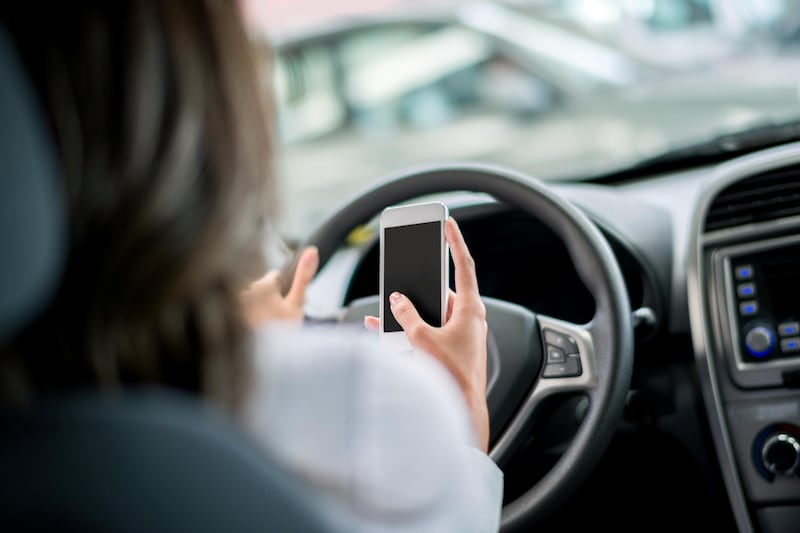Woman texting from her phone while driving