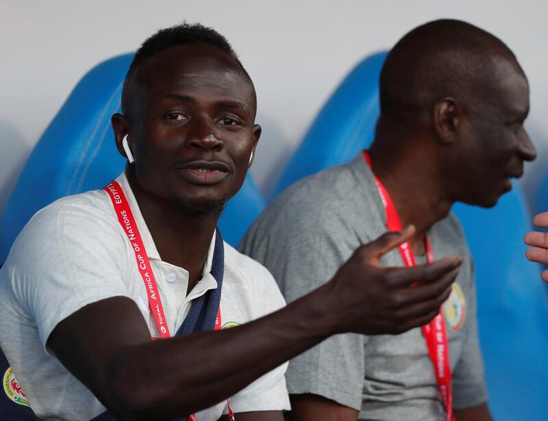Senegal's Sadio Mane sits on the bench during the match. The Liverpool forward was serving a one-match suspension. AFP