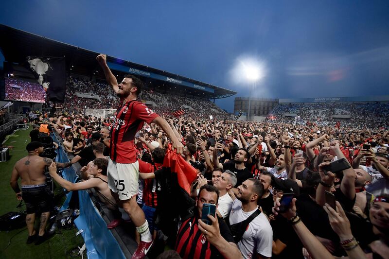 AC Milan midfielder Alessandro Florenzi celebrates with the fans. AFP