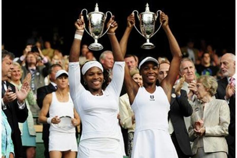 Serena Williams, left, and sister Venus, won the Wimbledon women's doubles title for the fourth time.