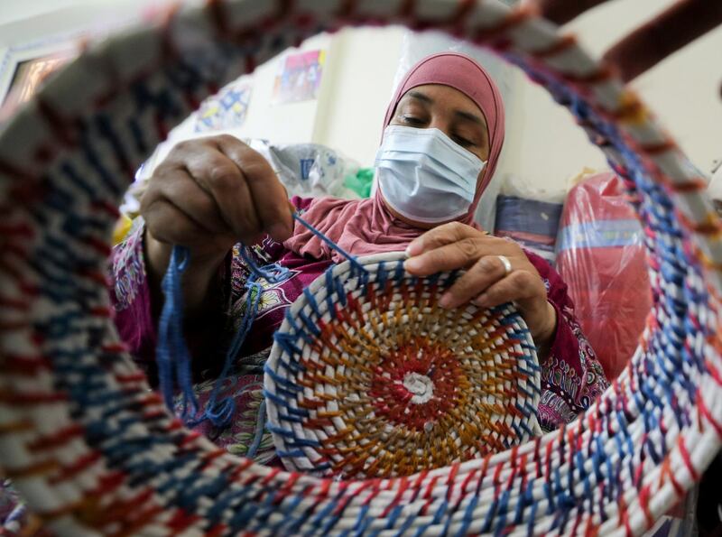 A woman weaves using recycled plastic from waste collected from the River Nile in Giza, Egypt. Reuters