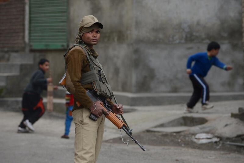 An Indian paramilitary trooper stands guard in downtown Srinagar as government forces enforce restrictions during a separatist strike demanding the Indian Army cease using a Kashmir meadow as its test firing range for heavy artillery. Tauseef Mustafa / AFP 