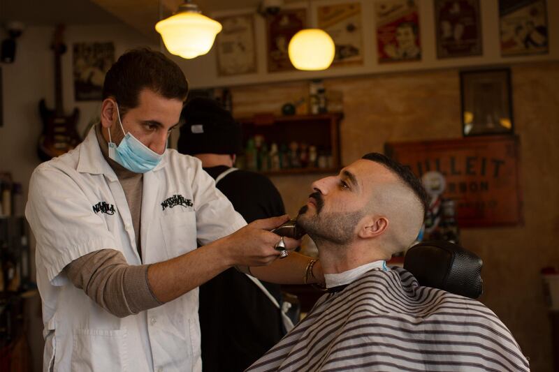 A customer at Nashville Barber Shop gets a shave after coronavirus restrictions were eased, opening shopping centres, gyms, barber shops, among other sites in Jerusalem.