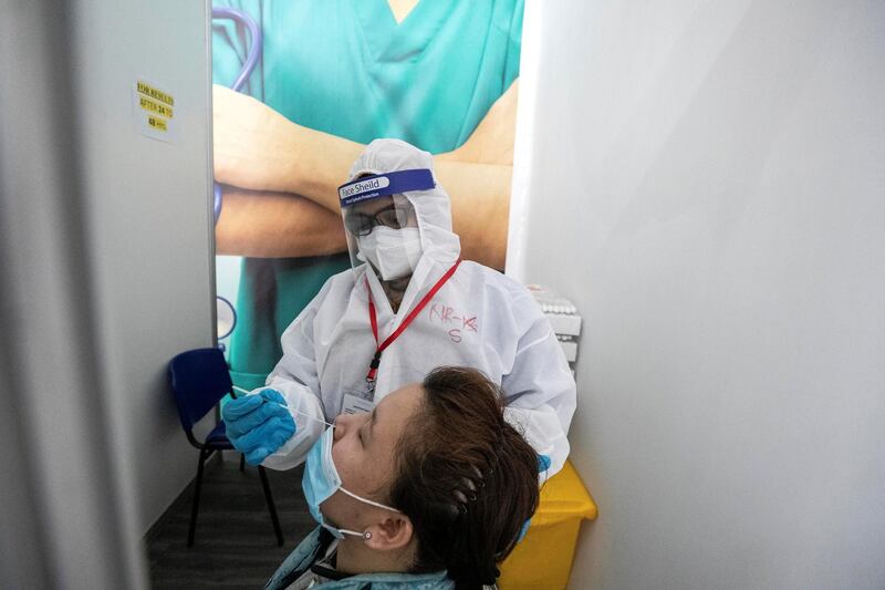 ABU DHABI, UNITED ARAB EMIRATES. 05 AUGUST 2020. The DPI Screening facility along the border between Dubai and Abu Dhabi which screens travellers for the COVID-19 virus using a blood sample and laser technology. It is a quick blood test and results are out in a matter of minutes. Regine Upod undertakes the secondary swab test. (Photo: Antonie Robertson/The National) Journalist: Nick Webster. Section: National.