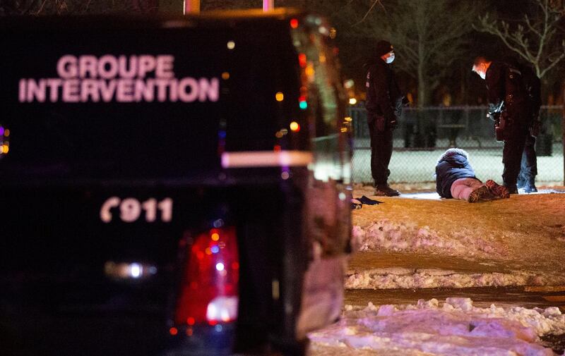 Police detain a protester as they enforce a night curfew imposed by the Quebec government to help slow the spread of the coronavirus disease (COVID-19) pandemic in Montreal, Quebec, Canada January 9, 2021.  REUTERS/Christinne Muschi